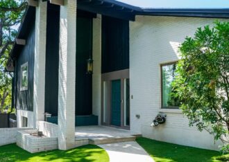 Artificial grass front lawn on both sides of a curved walkway to the front door