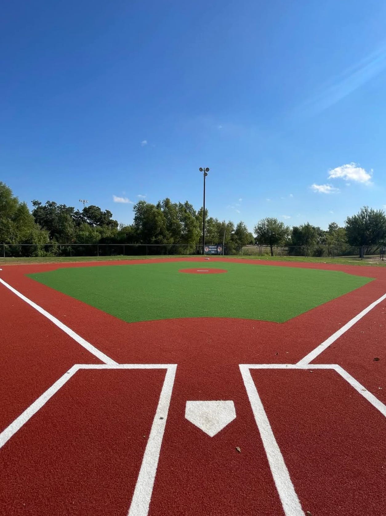 Baseball field built with green and red artificial sports turf