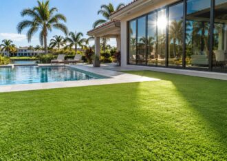 Artificial turf beside large low-E windows and a pool