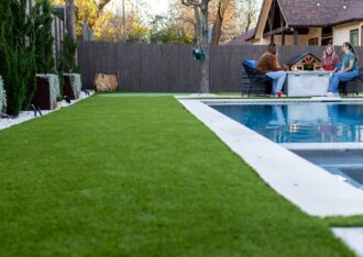 Artificial turf along a pool deck with a backyard putting green